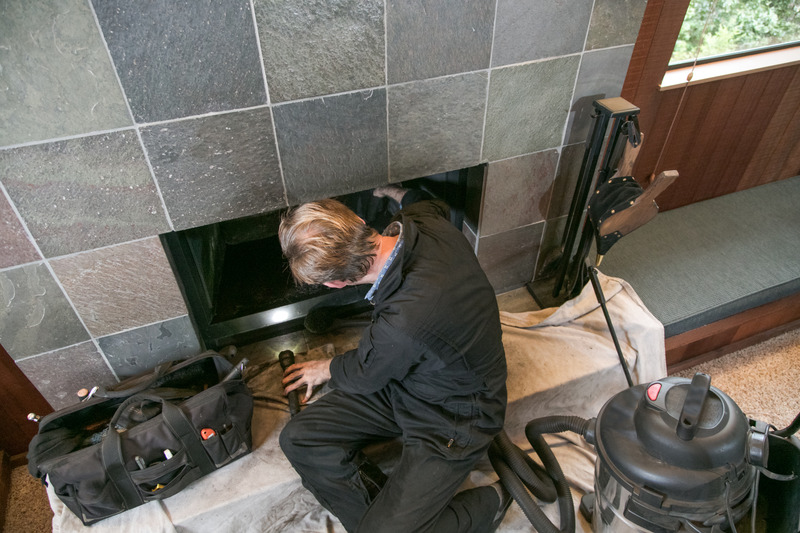 Chimney sweep cleaning a residential chimney in Seattle